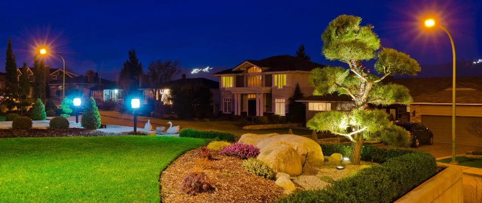 Front yard landscape of a property in Littleton, CO, with outdoor lighting.