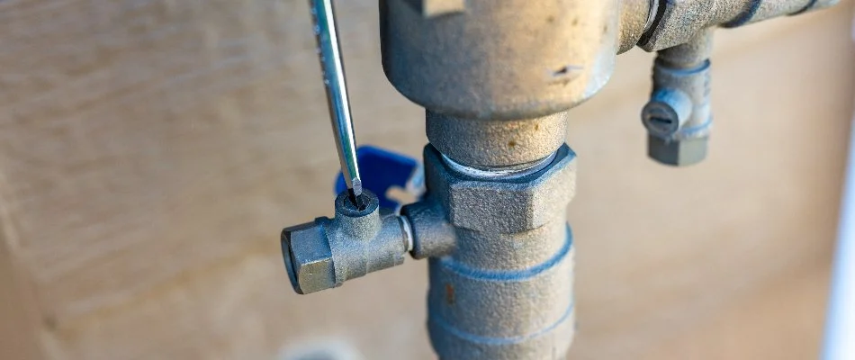 Turning on the water supply to an sprinkler system in Denver, CO.